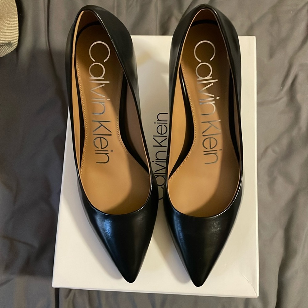 Calvin Klein black leather pump with a pointed toe.